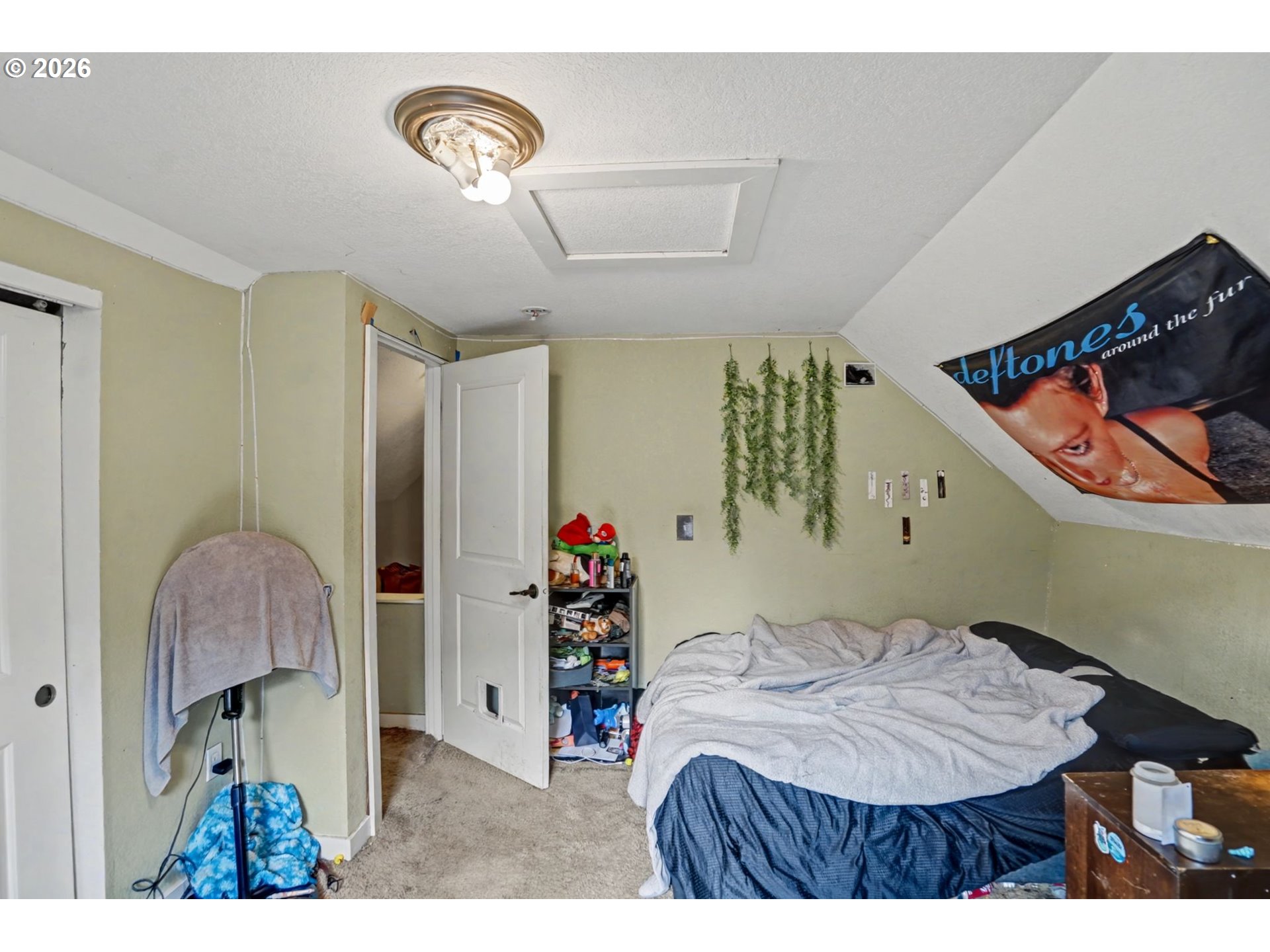 213 Mill Street Silverton, OR 97381 - Photo 17 of 25 a bedroom with a bed and a chandelier