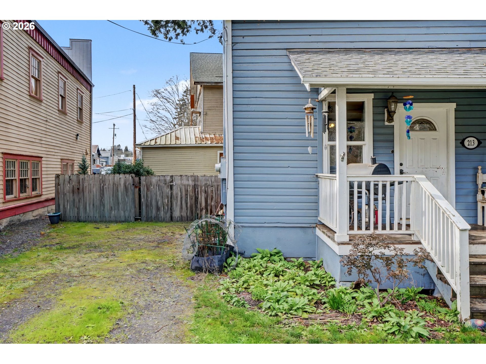 213 Mill Street Silverton, OR 97381 - Photo 3 of 25 a view of a house with a small yard and wooden fence