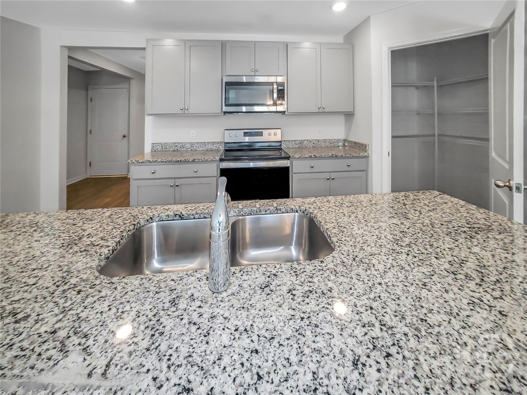 109 Barbados Circle Guyton, GA 31312 - Photo 16 of 46 KITCHEN WITH GRANITE COUNTERTOPS