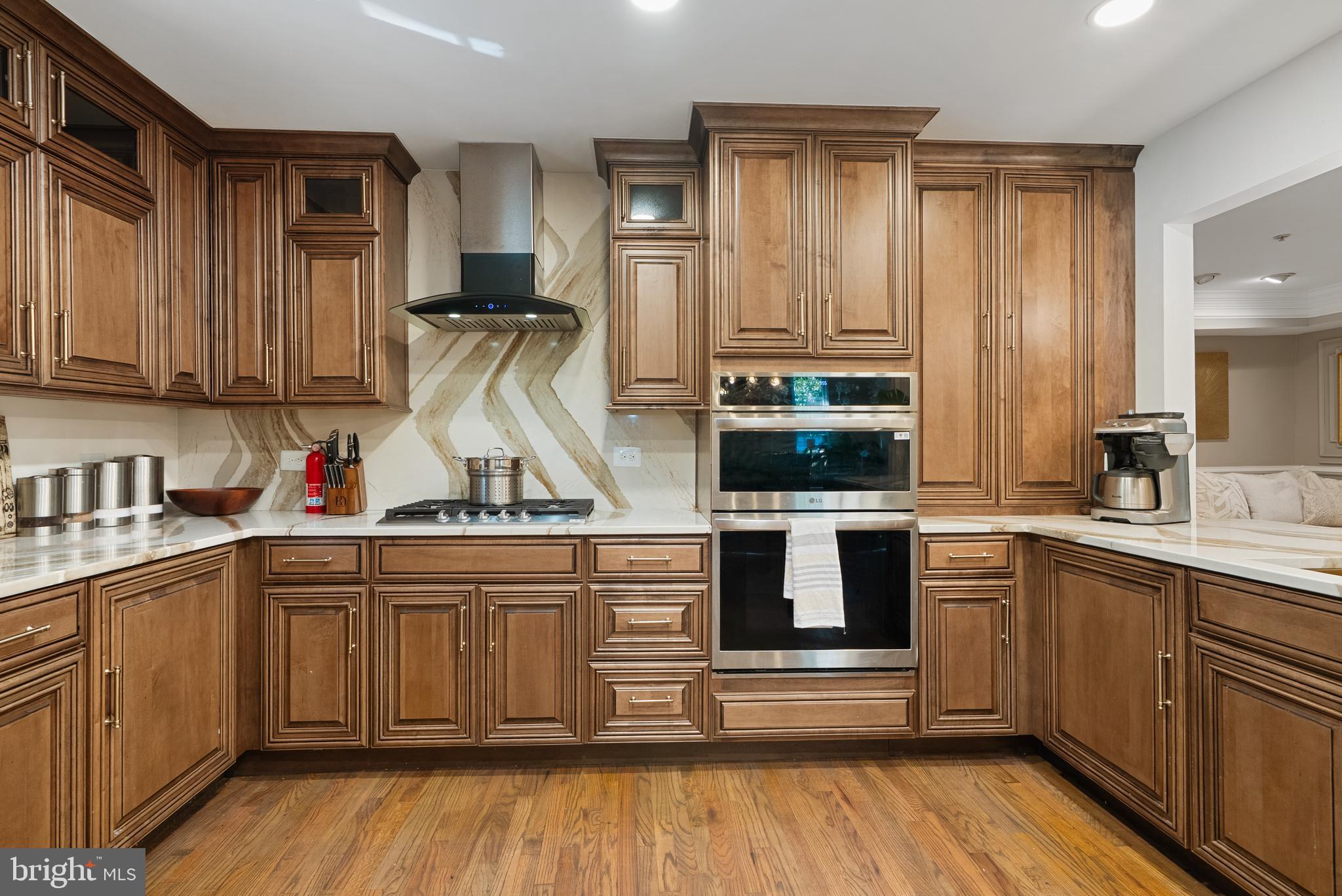 6202 State Street Cheverly, MD 20785 - Photo 12 of 34 a kitchen with stainless steel appliances granite countertop a stove and cabinets