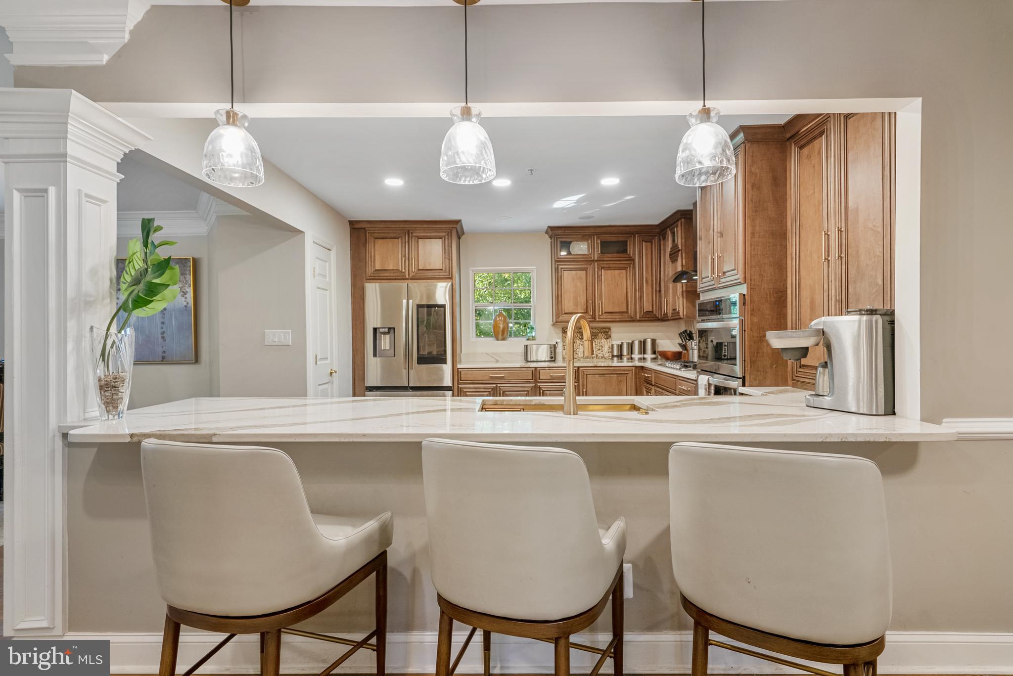 6202 State Street Cheverly, MD 20785 - Photo 13 of 34 a kitchen with stainless steel appliances granite countertop a sink a stove a refrigerator with chairs and cabinets