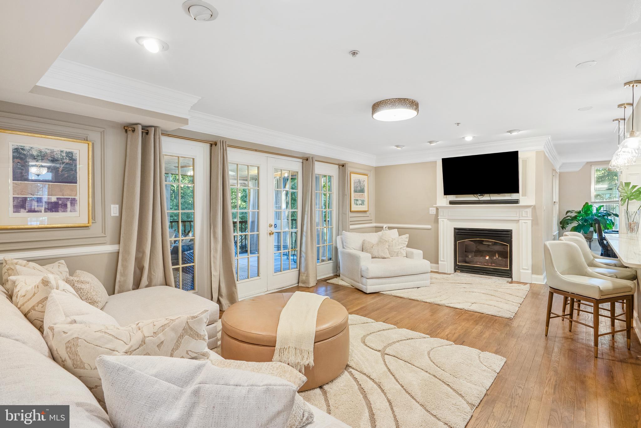 6202 State Street Cheverly, MD 20785 - Photo 7 of 34 a living room with furniture a fireplace and a flat screen tv