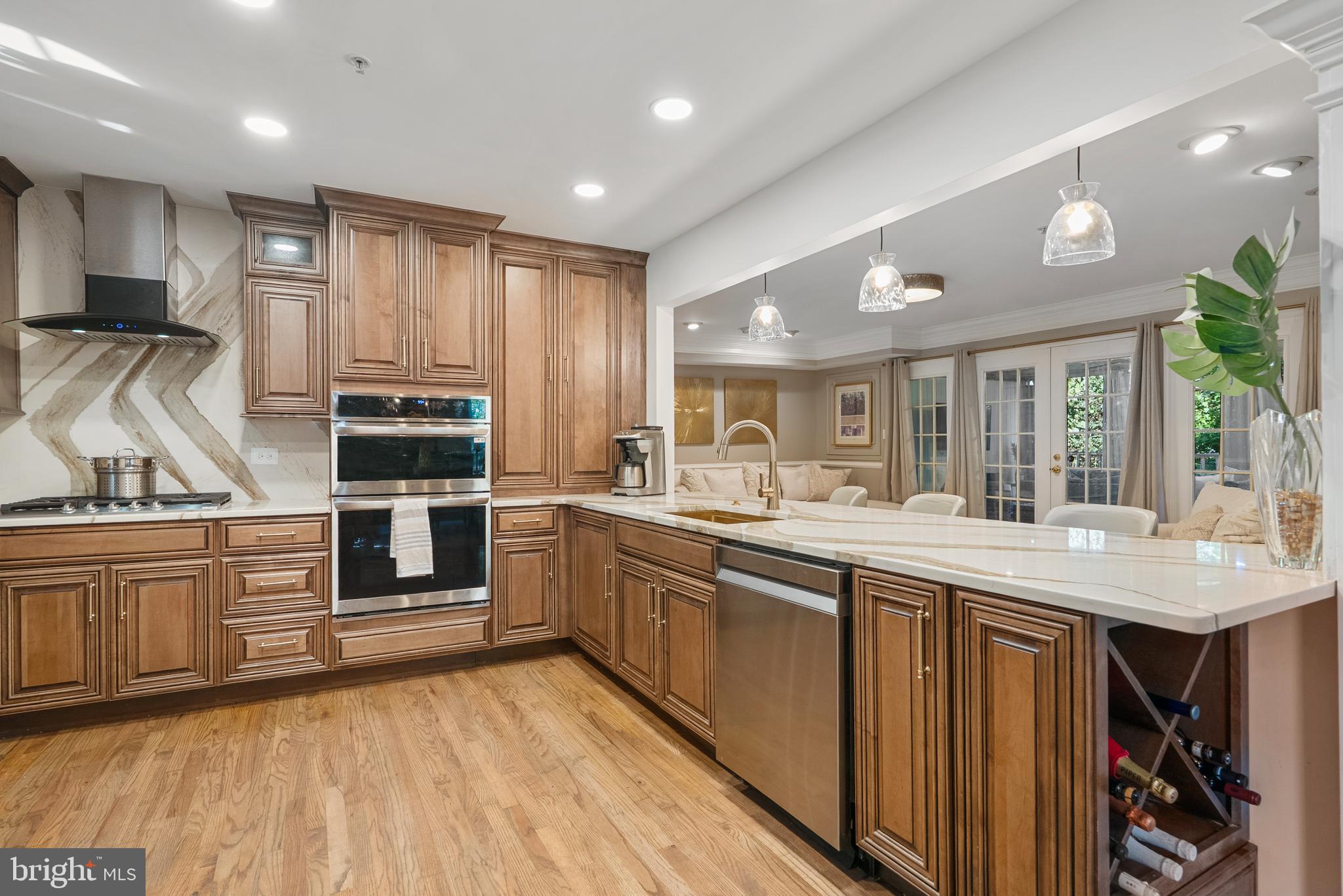 6202 State Street Cheverly, MD 20785 - Photo 9 of 34 a kitchen with stainless steel appliances granite countertop a stove top oven a sink dishwasher and cabinets with wooden floor