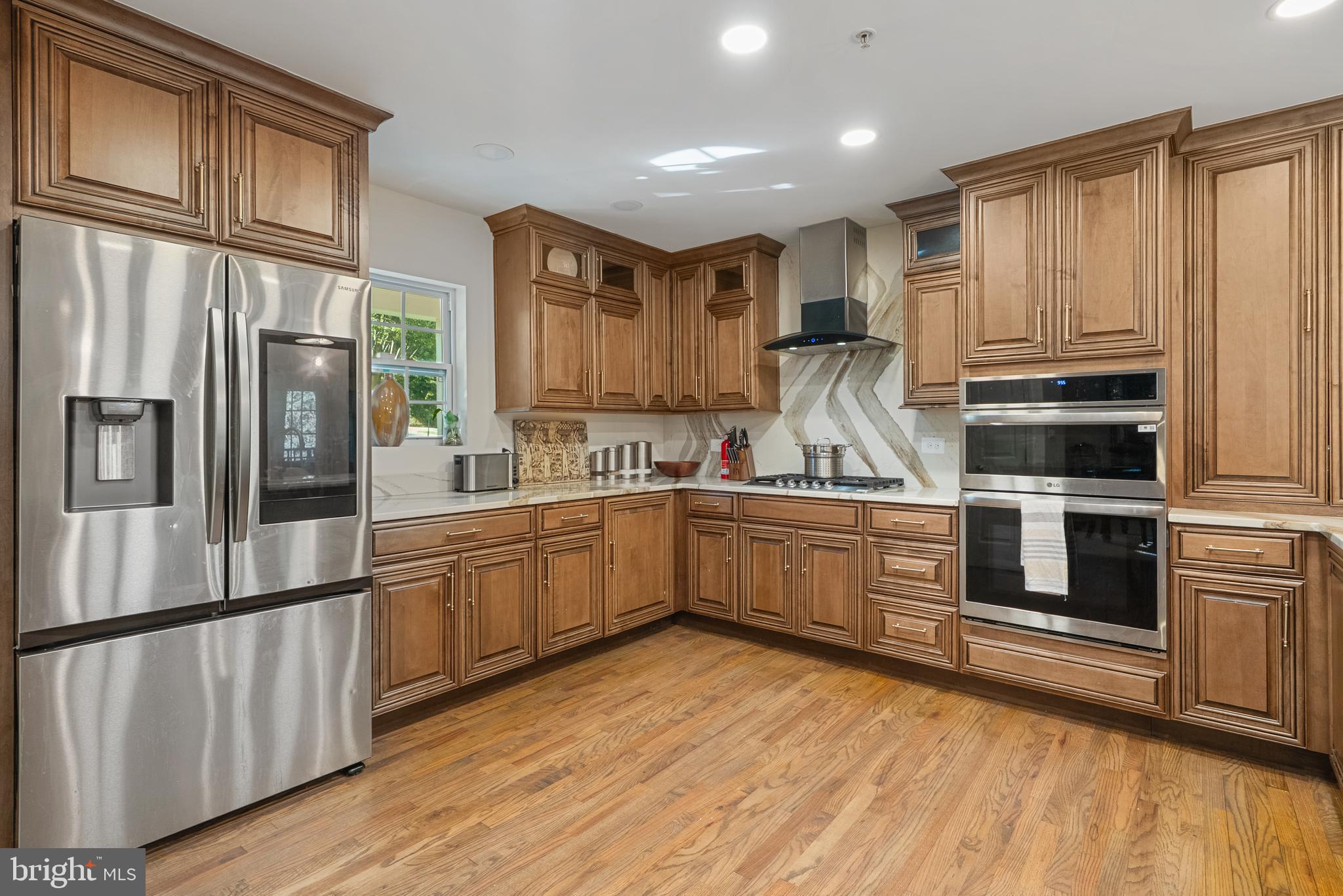 6202 State Street Cheverly, MD 20785 - Photo 10 of 34 a kitchen with stainless steel appliances granite countertop a refrigerator and a stove top oven