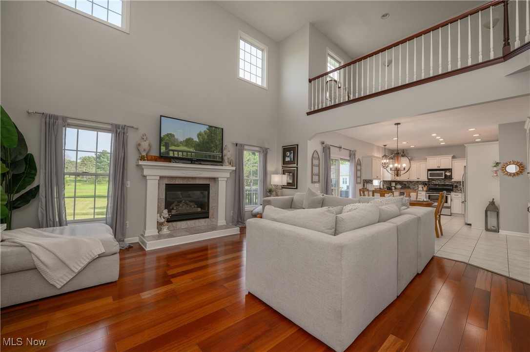 Open concept Living room with a wealth of natural light, fireplace and light hardwood / wood-style floors