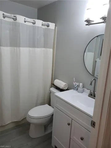 a bathroom with a sink vanity mirror and toilet