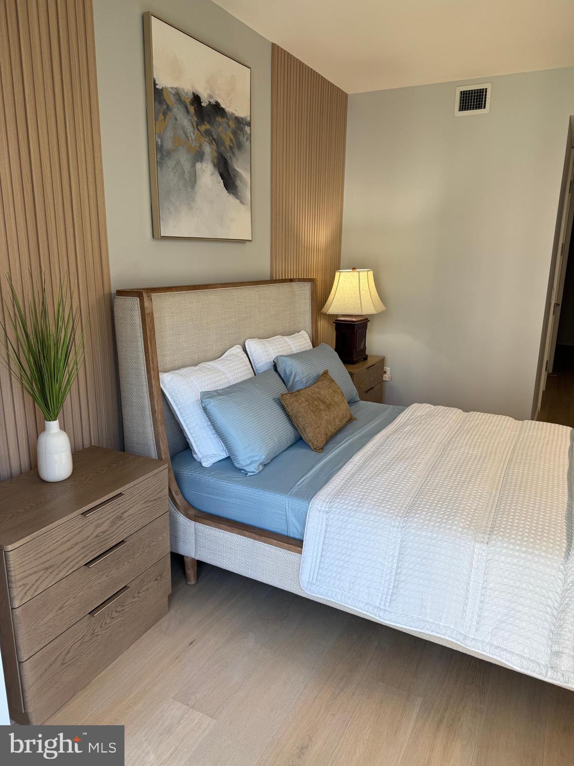 920 I Street Northwest, Unit 504505 Washington, DC 20001 - Photo 17 of 17 a bed sitting in a bedroom next to a lamp