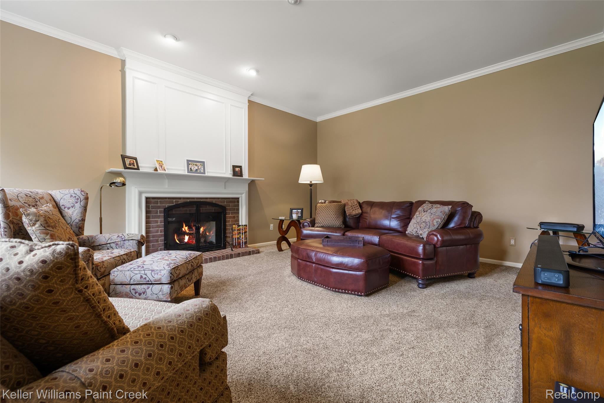 1933 Catlin Drive Rochester, MI 48306 - Photo 20 of 54 Living room with crown molding, carpet flooring, and a fireplace