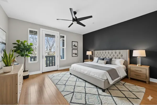 a bedroom with a large bed chandelier and a window