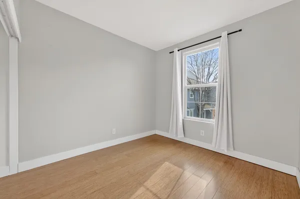 an empty room with windows and closet