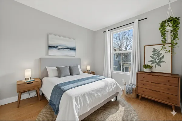 a bedroom with a bed and a window