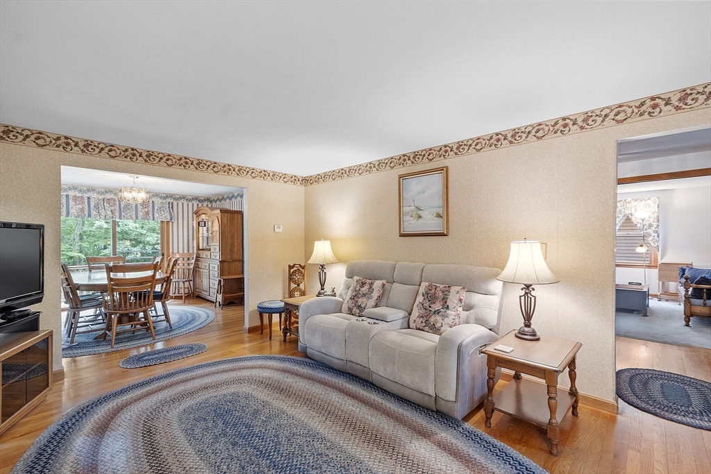 310 Simonds Road Ashby, MA 01431 - Photo 5 of 40 a living room with furniture and a flat screen tv with wooden floor