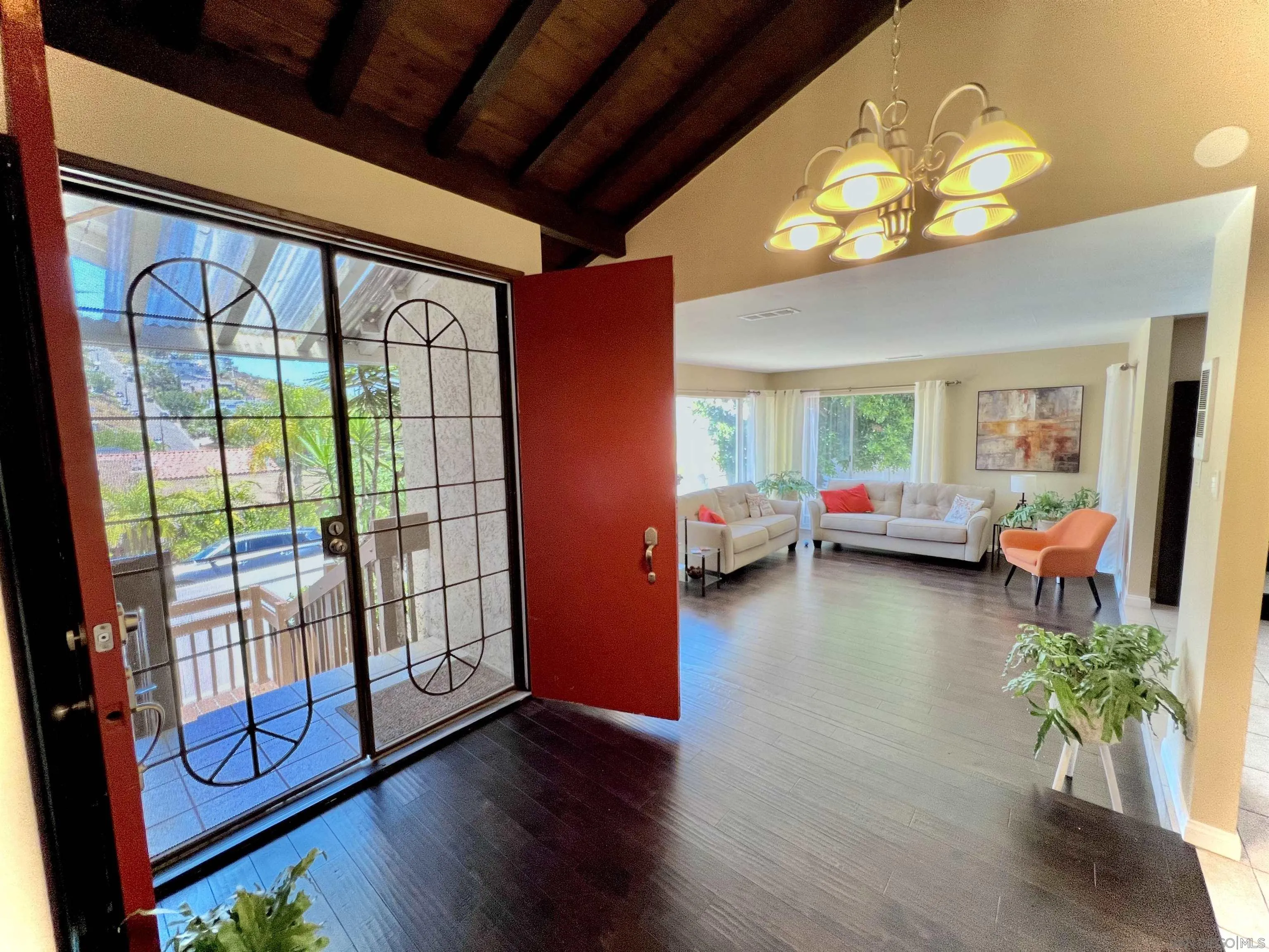 a living room with furniture and a floor to ceiling window