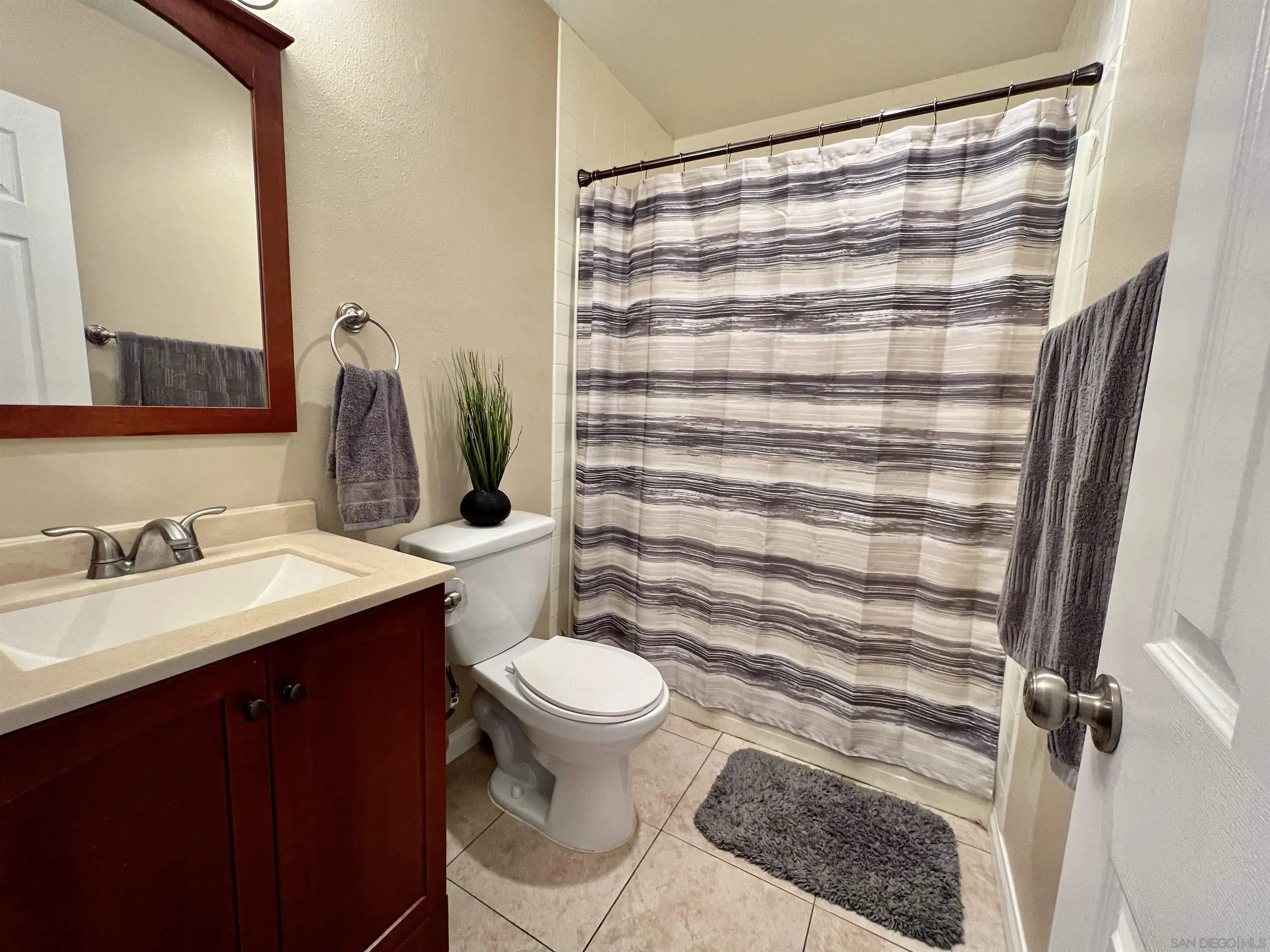 9849 Chestnut Street Spring Valley, CA 91977 - Photo 12 of 27 a bathroom with a sink toilet and shower