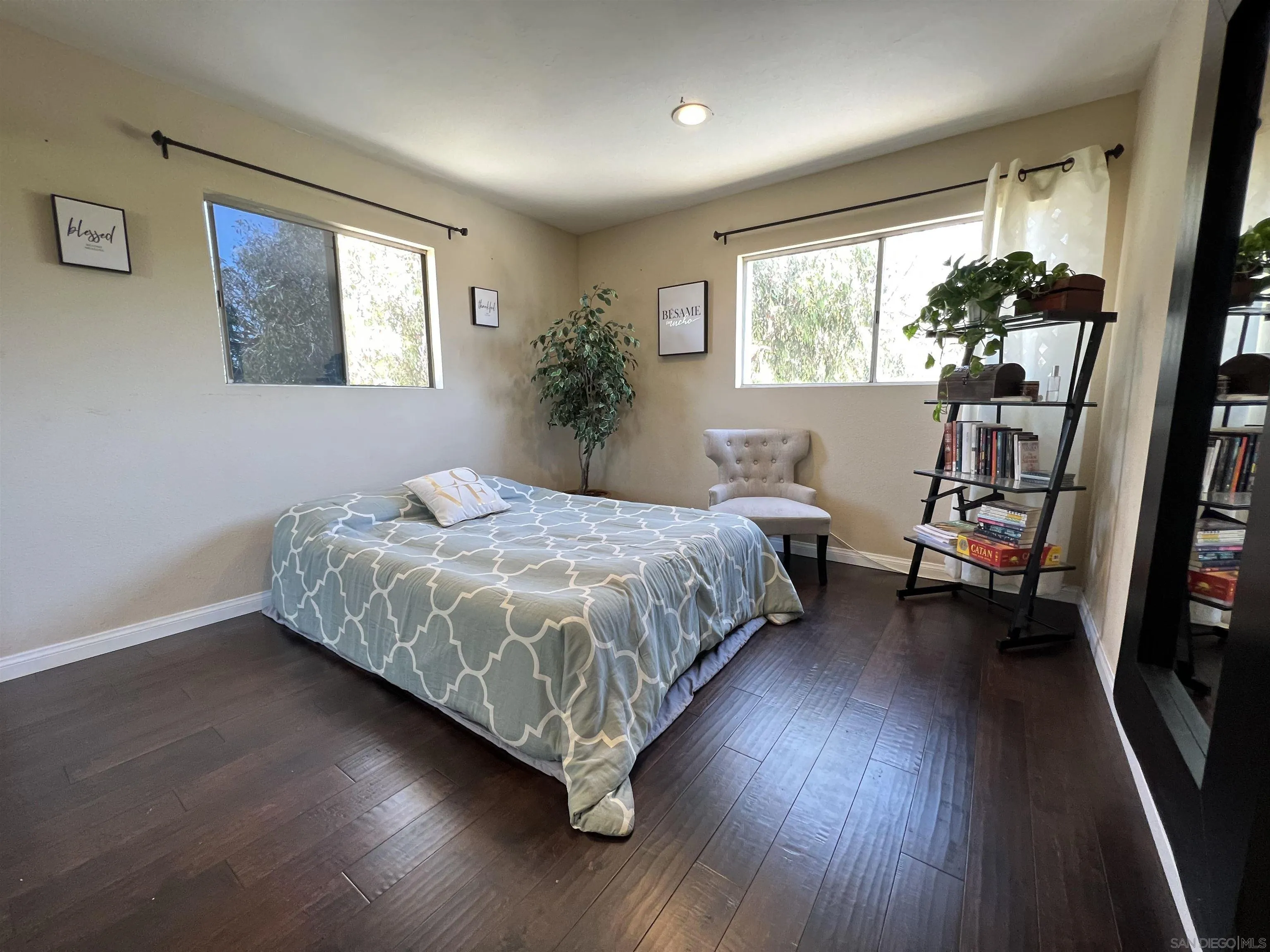 9849 Chestnut Street Spring Valley, CA 91977 - Photo 14 of 27 a bedroom with a large bed and a window