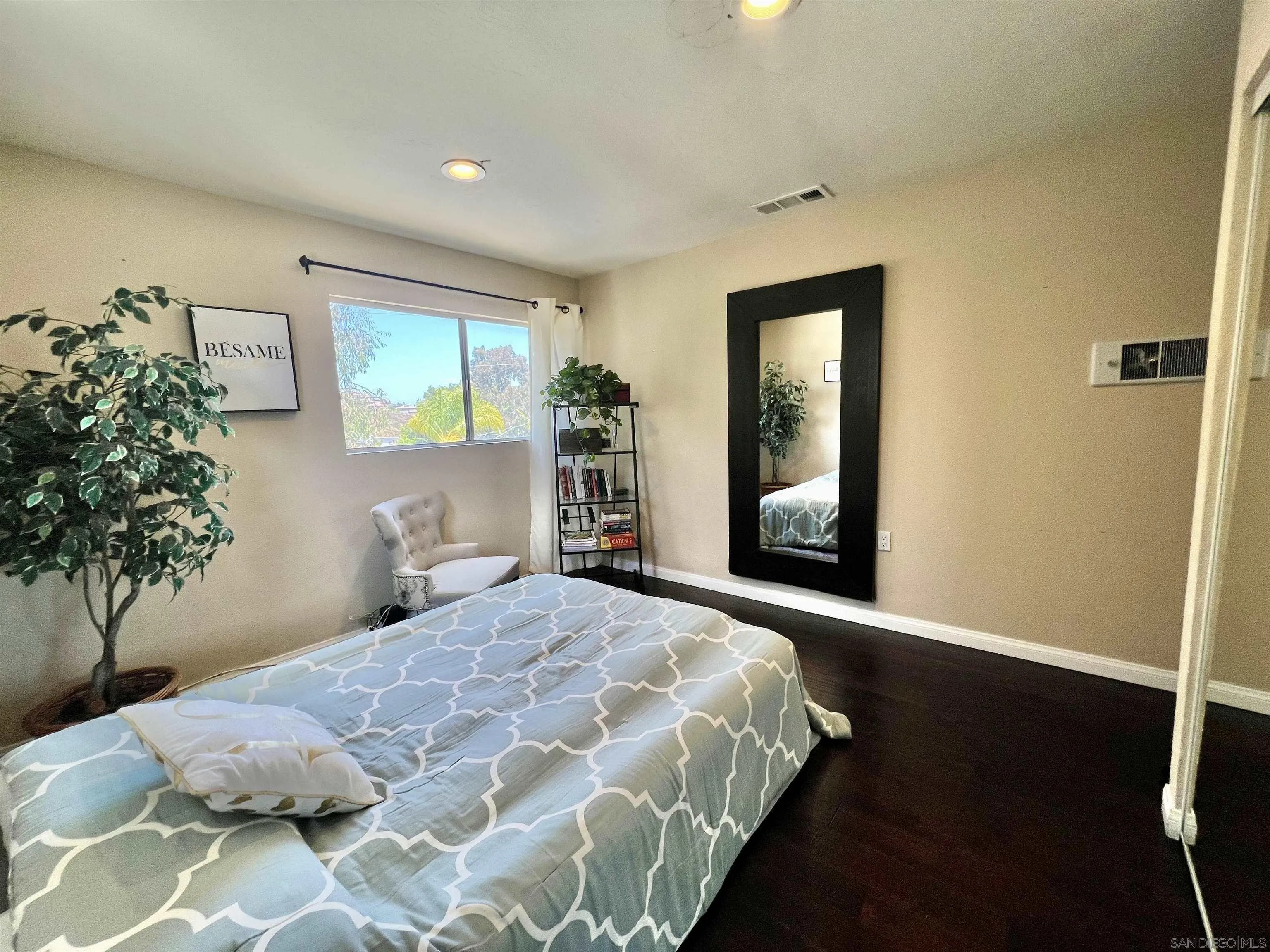 9849 Chestnut Street Spring Valley, CA 91977 - Photo 15 of 27 a bedroom with a bed and a window