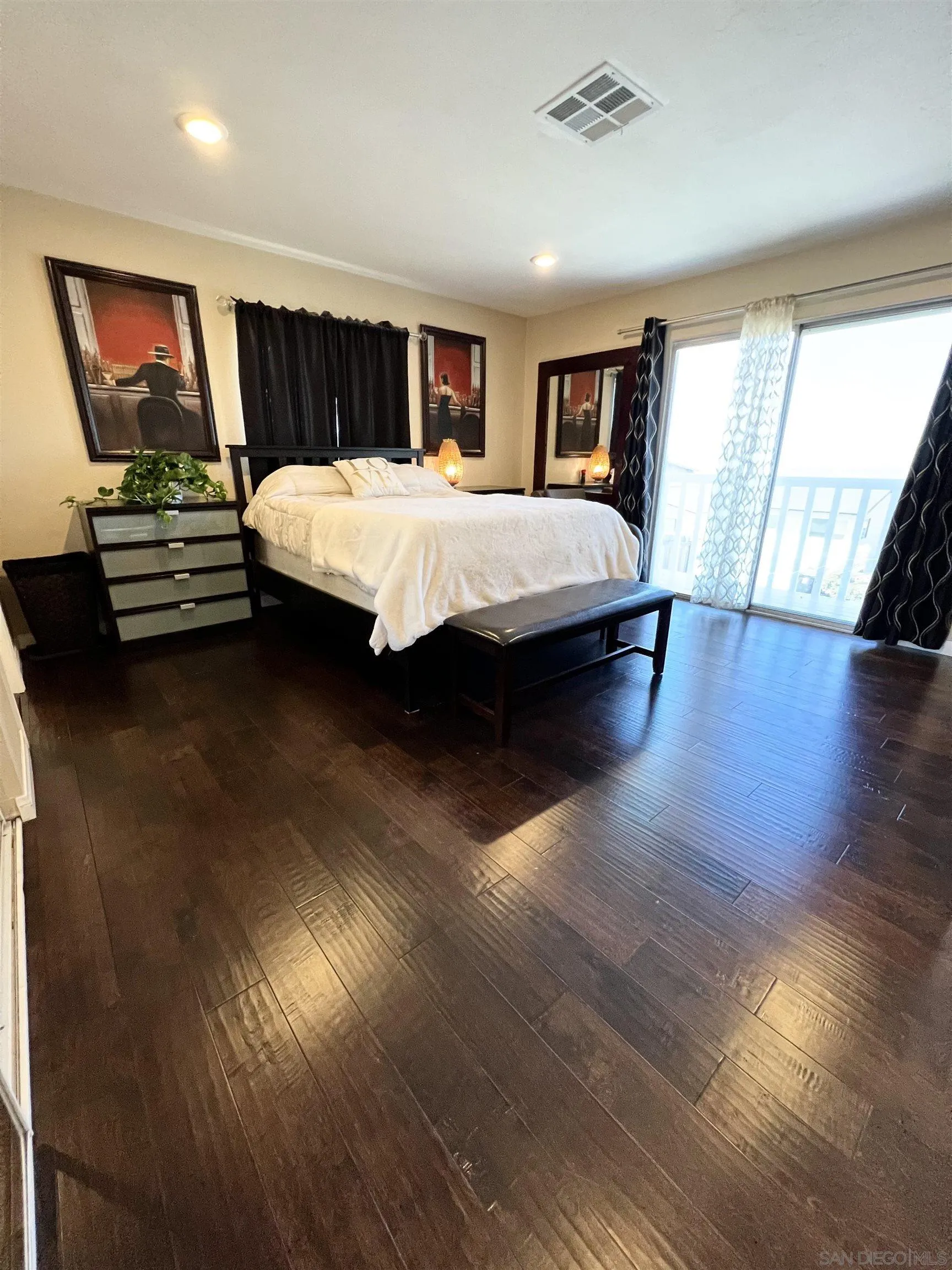 9849 Chestnut Street Spring Valley, CA 91977 - Photo 16 of 27 a bedroom with a bed and wooden floor