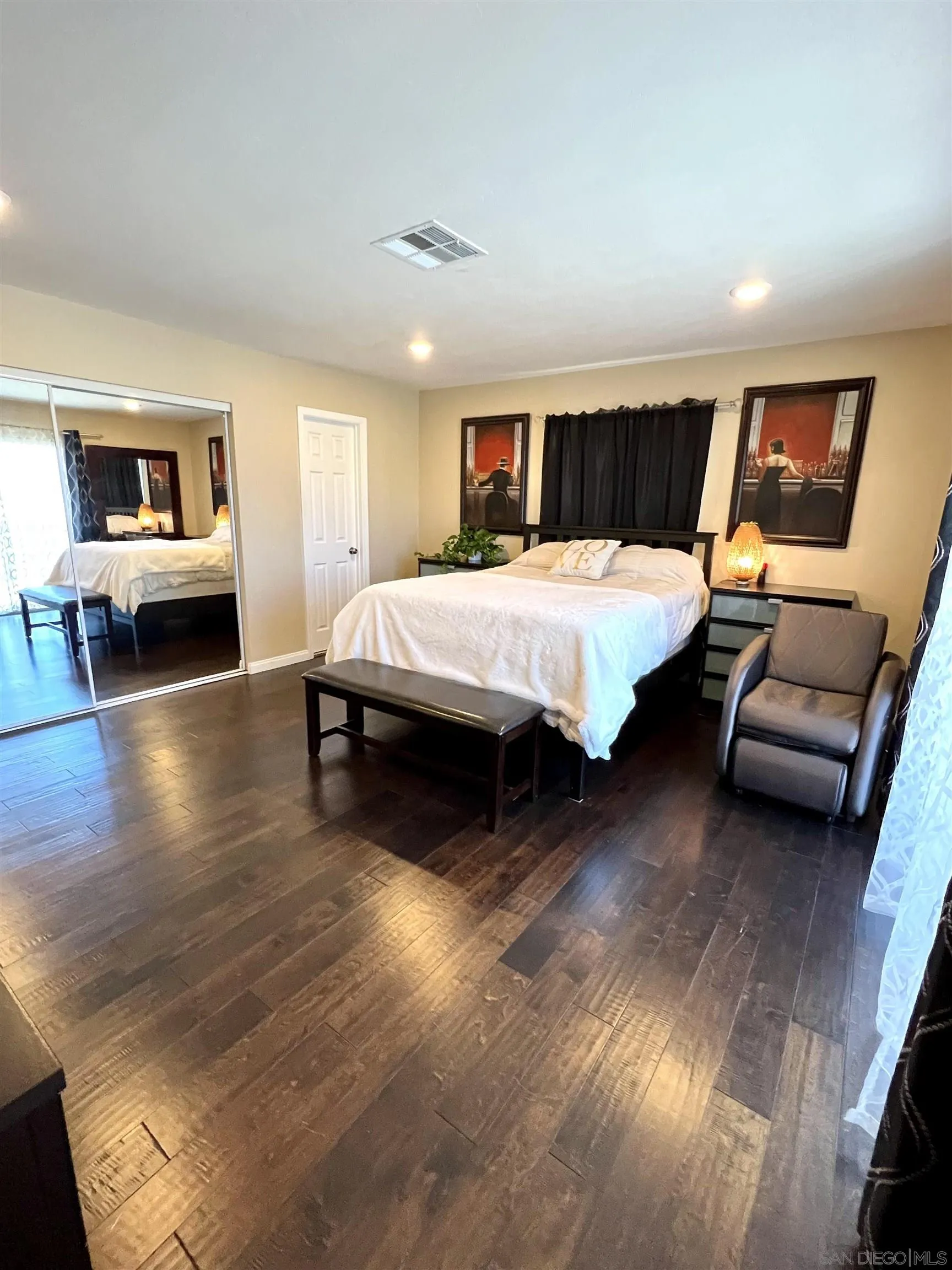 9849 Chestnut Street Spring Valley, CA 91977 - Photo 17 of 27 a bedroom with a bed and wooden floor