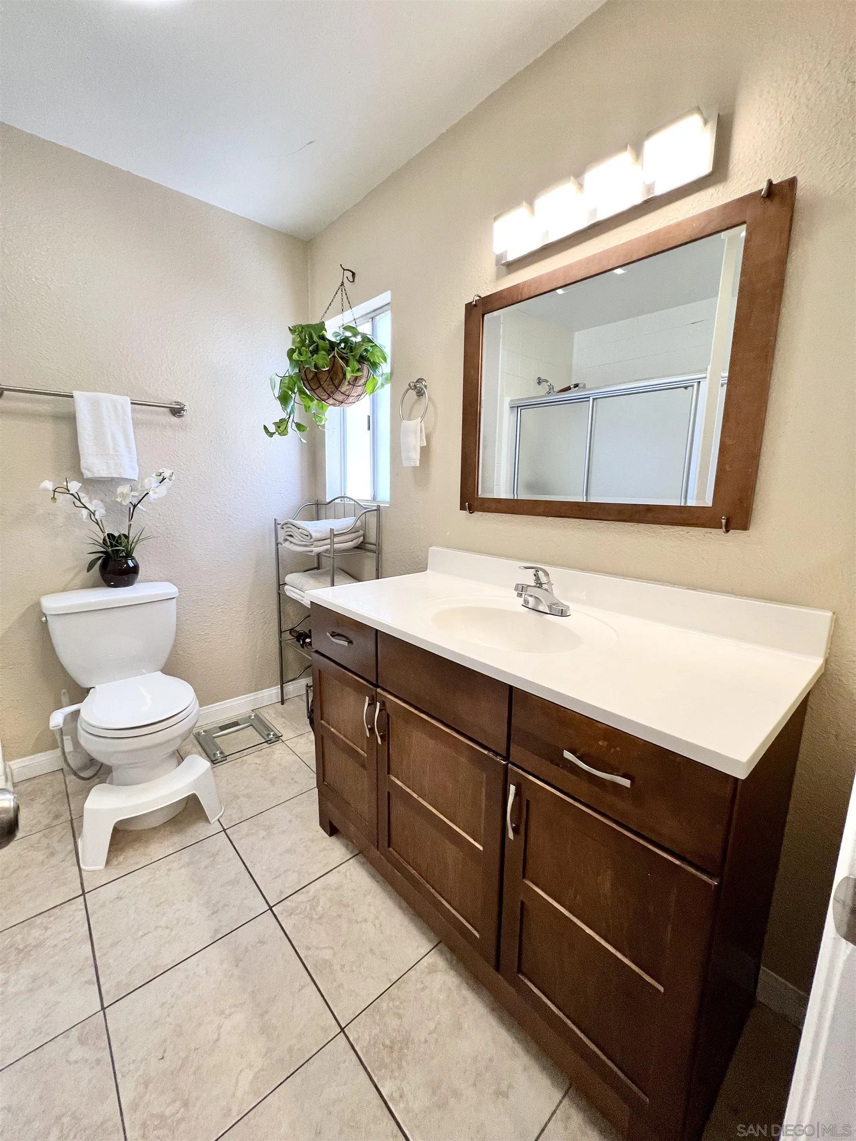 9849 Chestnut Street Spring Valley, CA 91977 - Photo 19 of 27 a bathroom with a sink vanity and a mirror