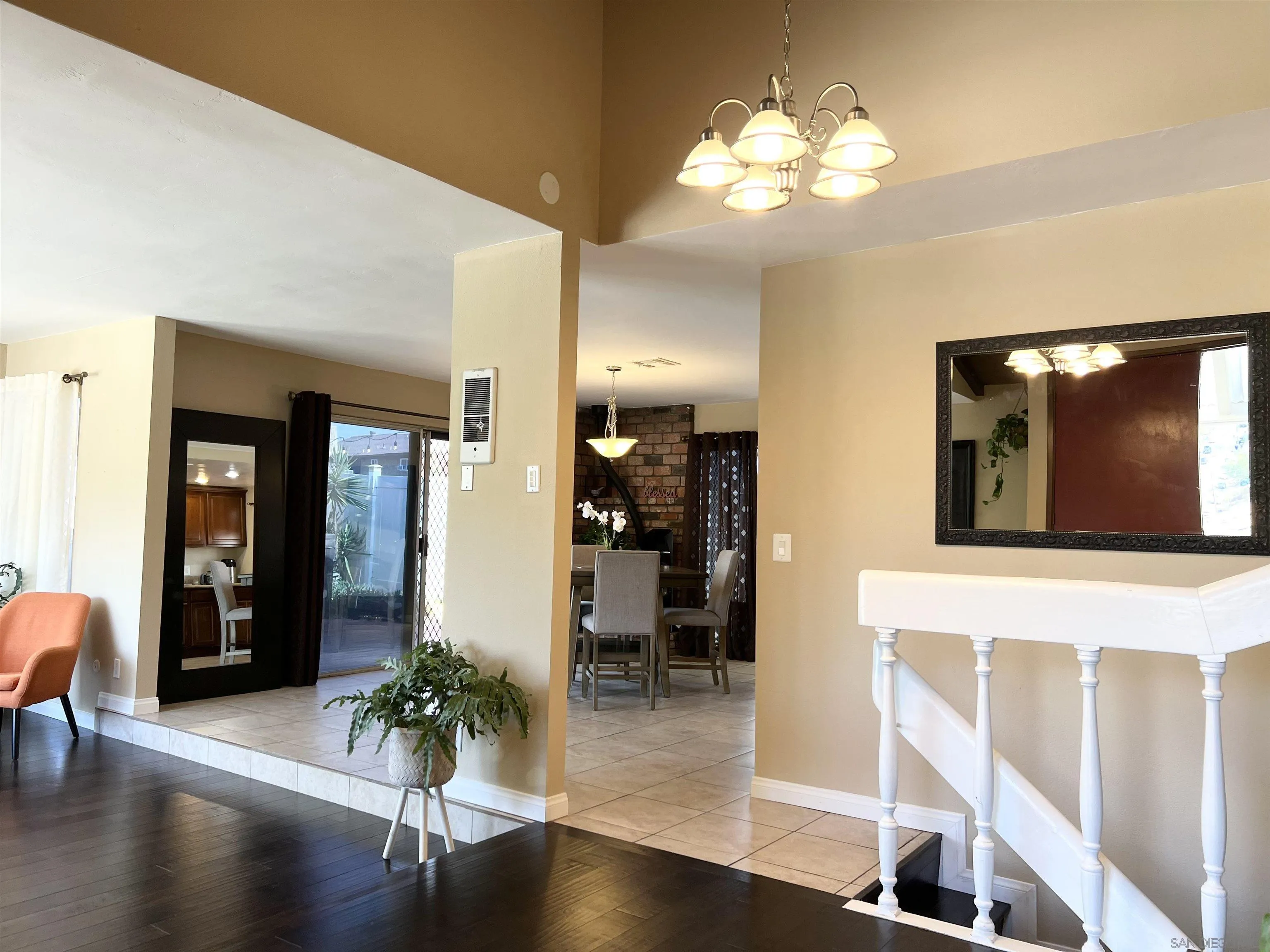 9849 Chestnut Street Spring Valley, CA 91977 - Photo 2 of 27 a view of a hallway with wooden floor and a living room
