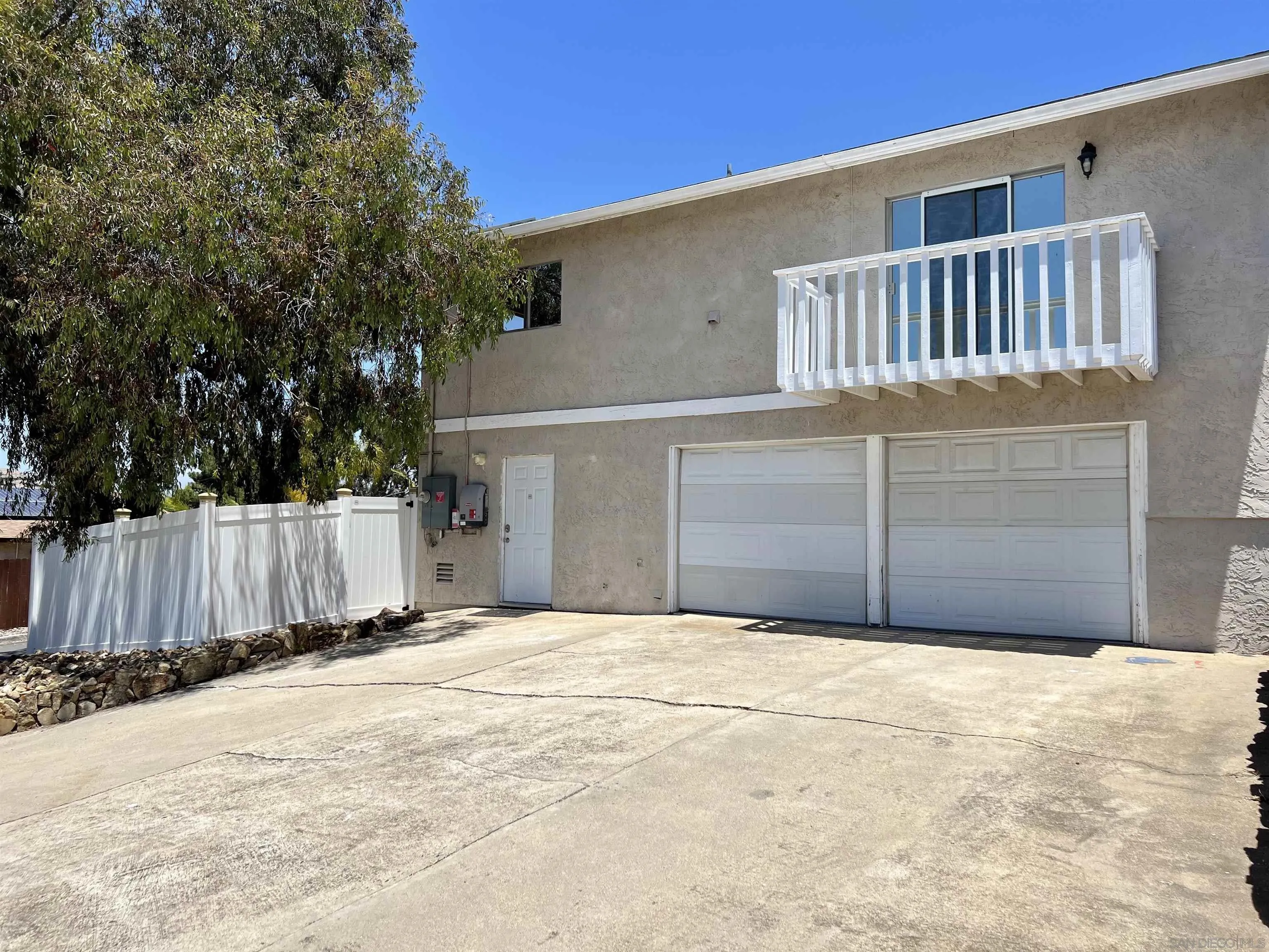 9849 Chestnut Street Spring Valley, CA 91977 - Photo 24 of 27 a front view of a house with a fence