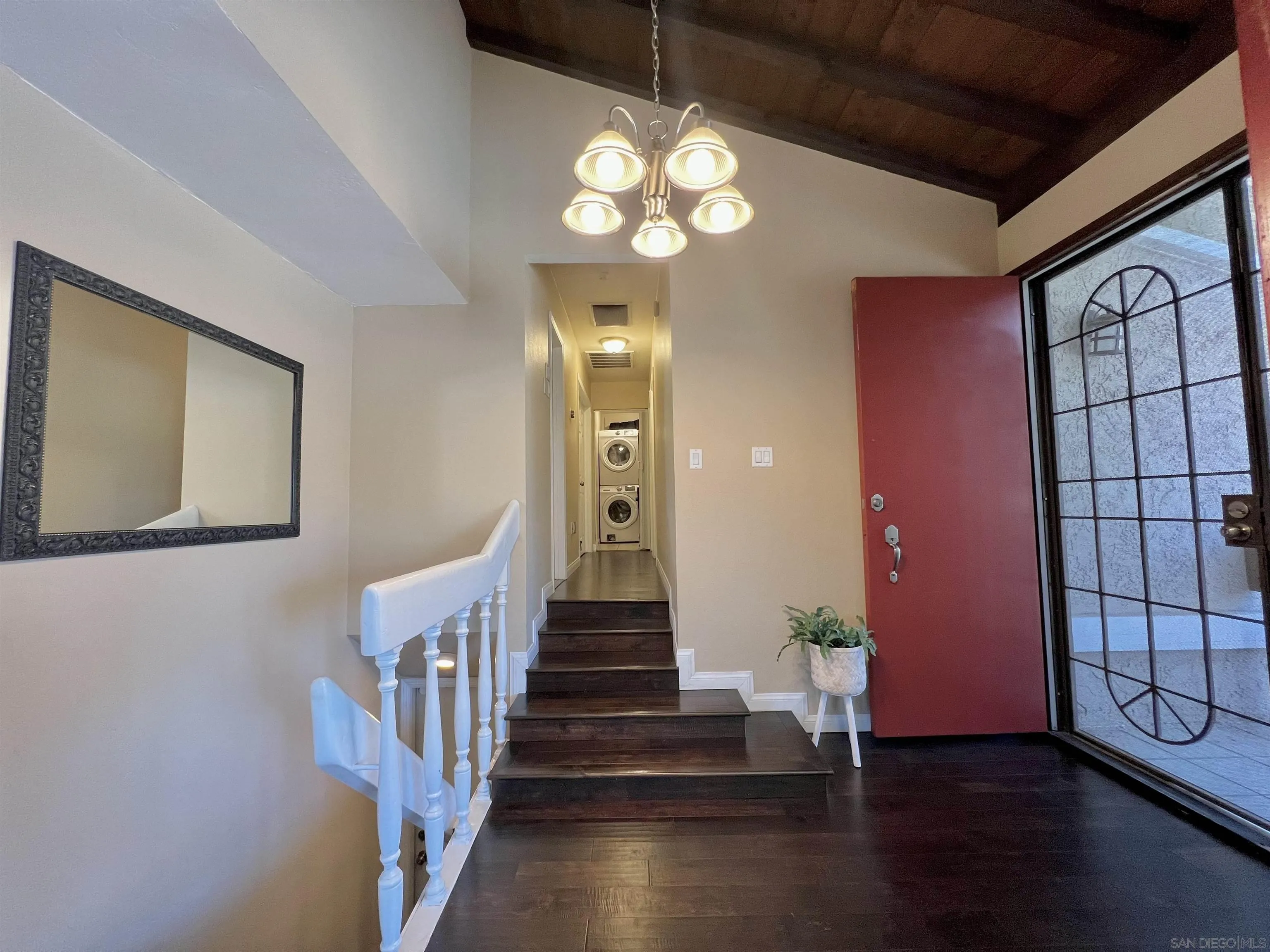 9849 Chestnut Street Spring Valley, CA 91977 - Photo 9 of 27 a view of a hallway with wooden floor and staircase
