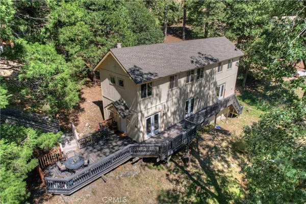 a view of a wooden house with a yard