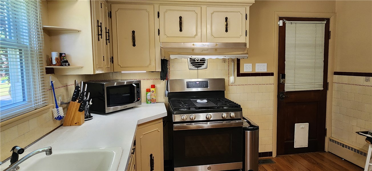 58 Ridge Street Woonsocket, RI 02895 - Photo 11 of 18 New stainless gas range and breezeway door.