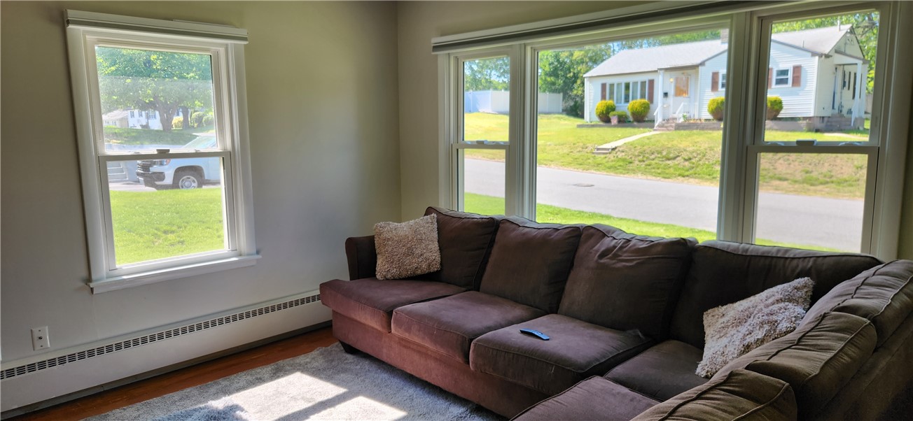 58 Ridge Street Woonsocket, RI 02895 - Photo 14 of 18 Bright living room with new windows and powered blinds and new front door.