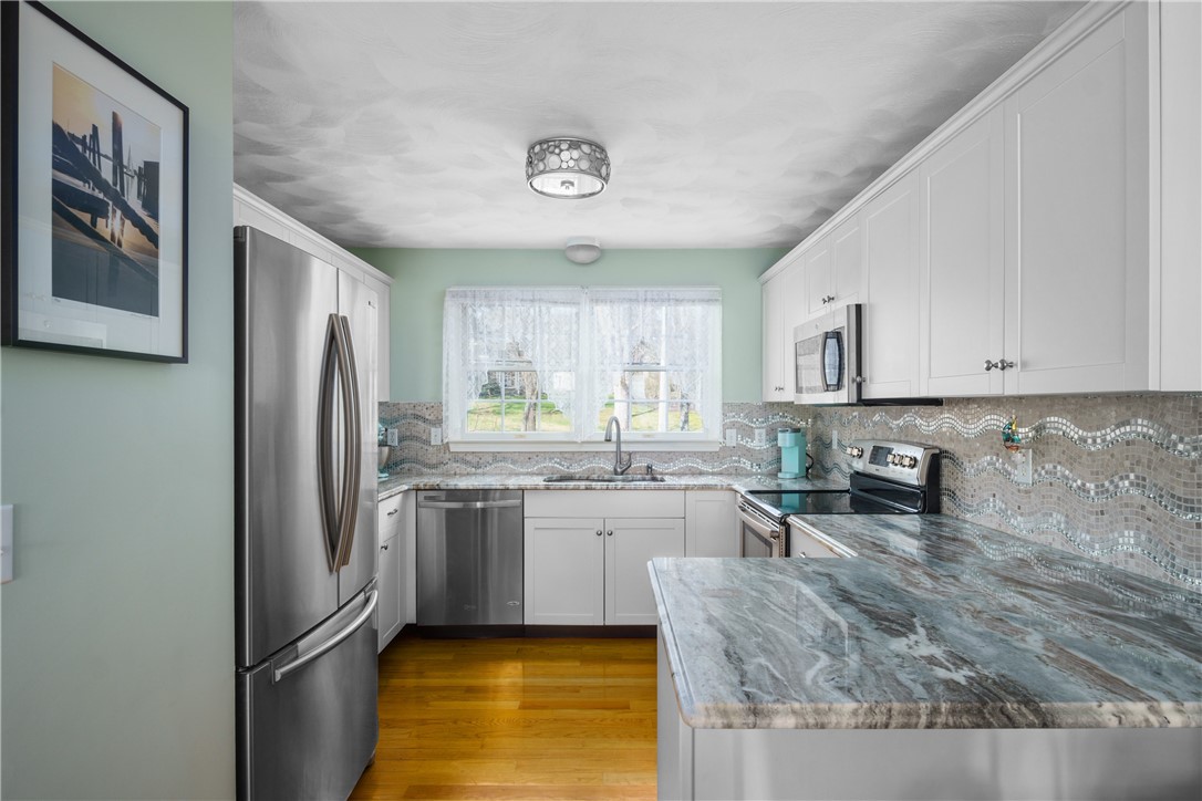 4400 Post Road, Unit 1 Warwick, RI 02818 - Photo 6 of 32 Kitchen with granite counters, stainless appliances and tile back splash