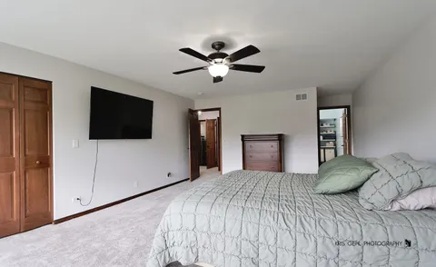 a bedroom with a large bed and a flat screen tv