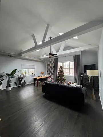 a living room with furniture and flowers
