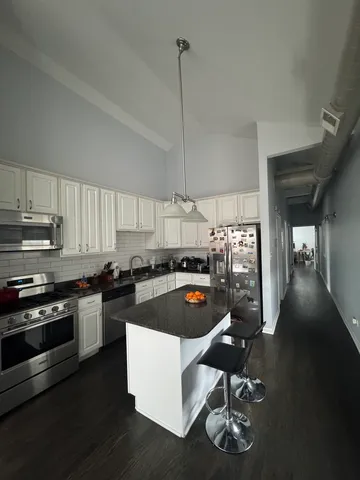 a room with furniture a rug and white walls