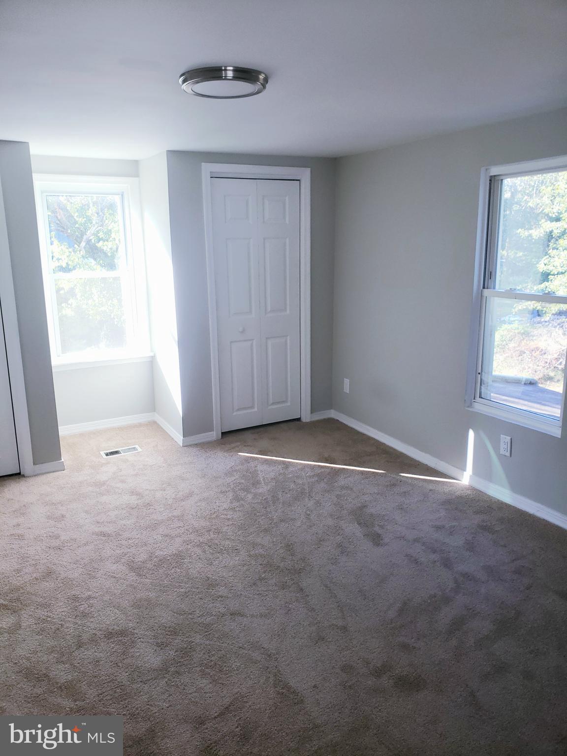 595 Berlin Road Clementon, NJ 08021 - Photo 11 of 24 an empty room with windows