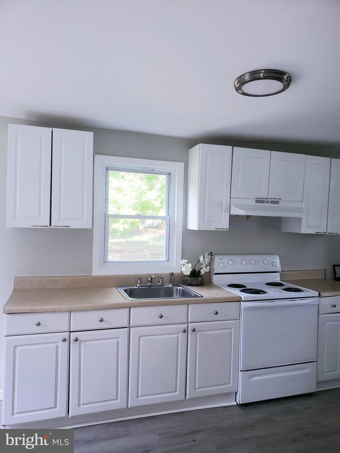 595 Berlin Road Clementon, NJ 08021 - Photo 3 of 24 a kitchen with granite countertop white cabinets white appliances and a sink