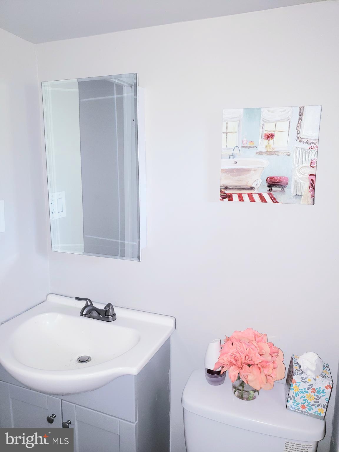 595 Berlin Road Clementon, NJ 08021 - Photo 9 of 24 a bathroom with a sink and a white vanity