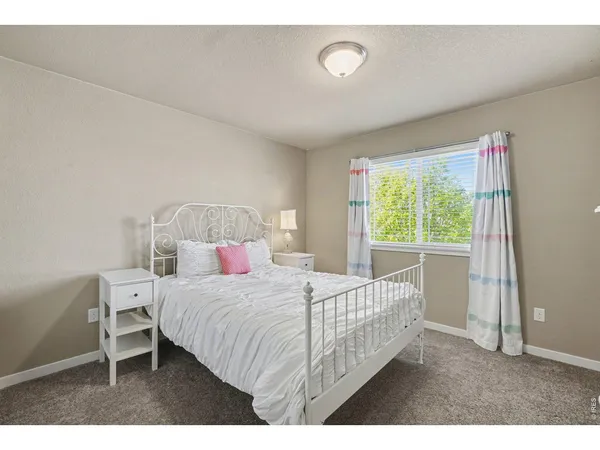 a bedroom with furniture and a window