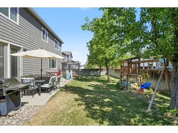 a view of a house with backyard and sitting area