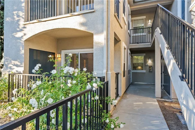 a view of a house with a flower plants next to a road