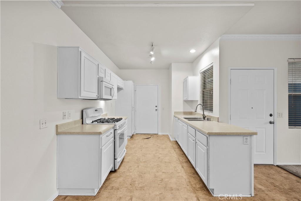 20000 Plum Canyon Road, Unit 1316 Saugus, CA 91350 - Photo 13 of 37 a kitchen with stainless steel appliances granite countertop a sink and cabinets