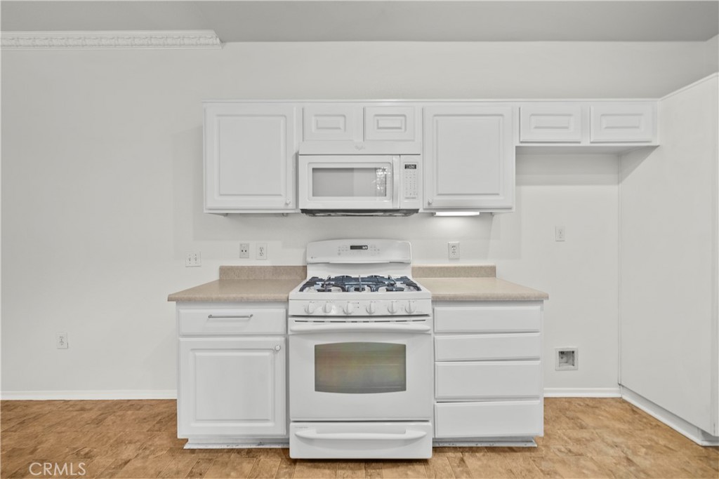 20000 Plum Canyon Road, Unit 1316 Saugus, CA 91350 - Photo 15 of 37 a white stove top oven sitting inside of a kitchen