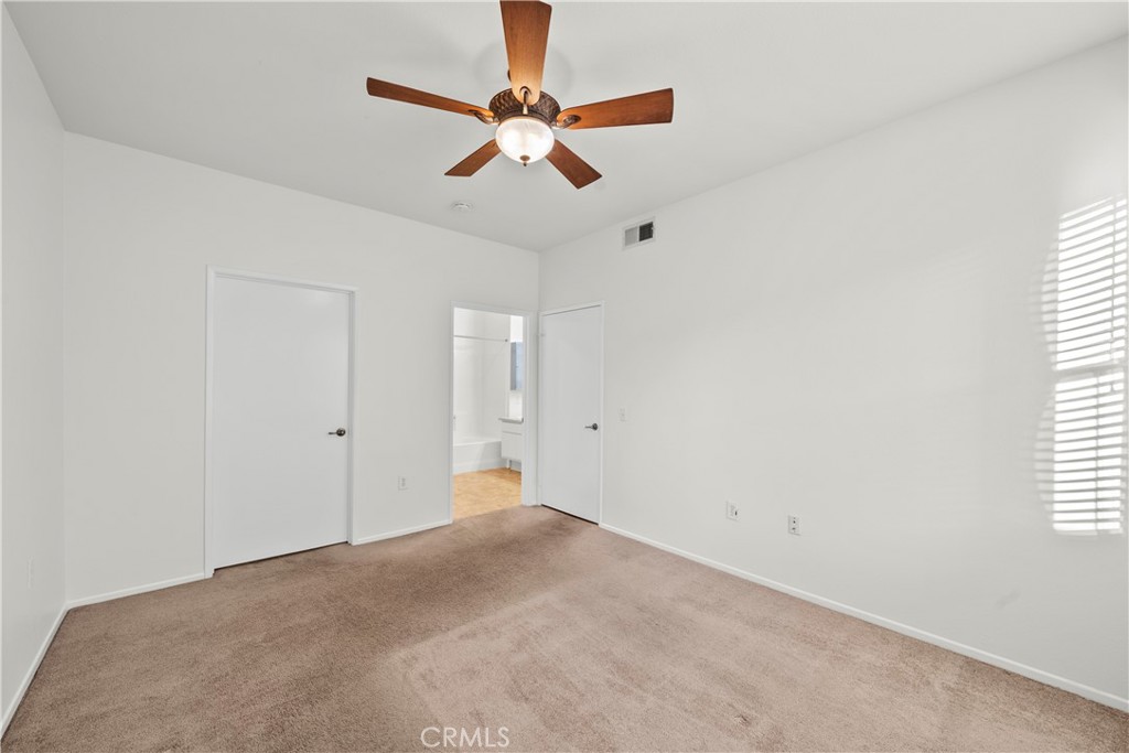 20000 Plum Canyon Road, Unit 1316 Saugus, CA 91350 - Photo 17 of 37 a view of a room with a ceiling fan and a window