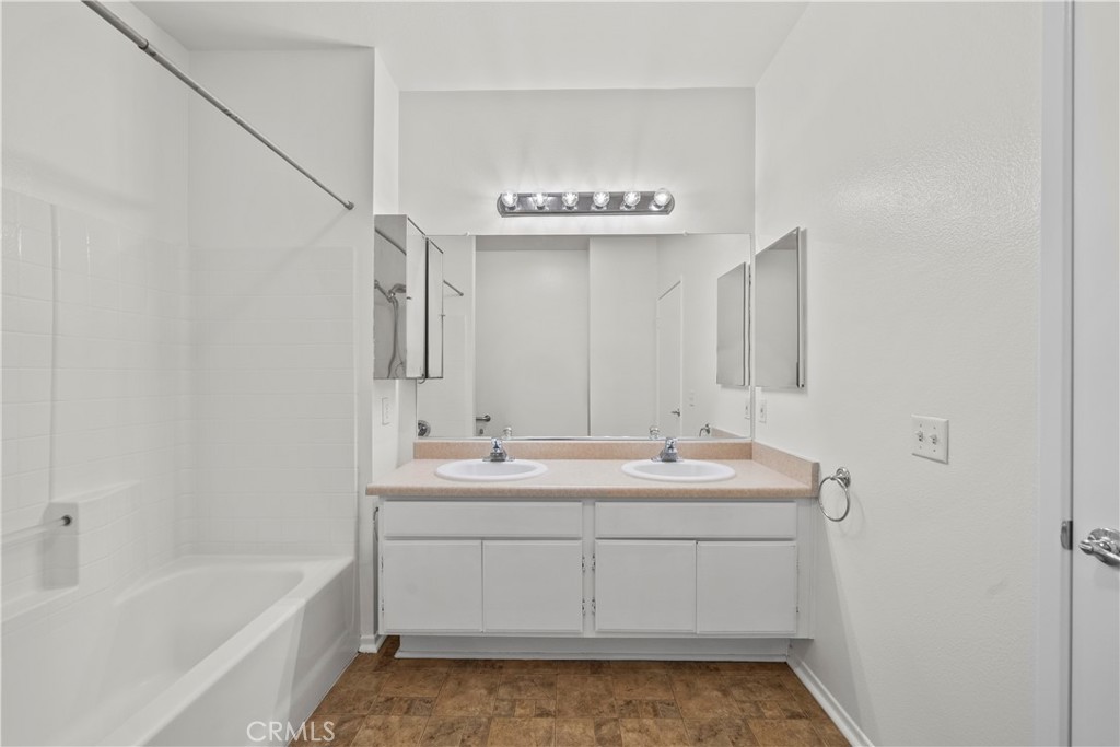 20000 Plum Canyon Road, Unit 1316 Saugus, CA 91350 - Photo 24 of 37 a bathroom with a sink a mirror and a bathtub