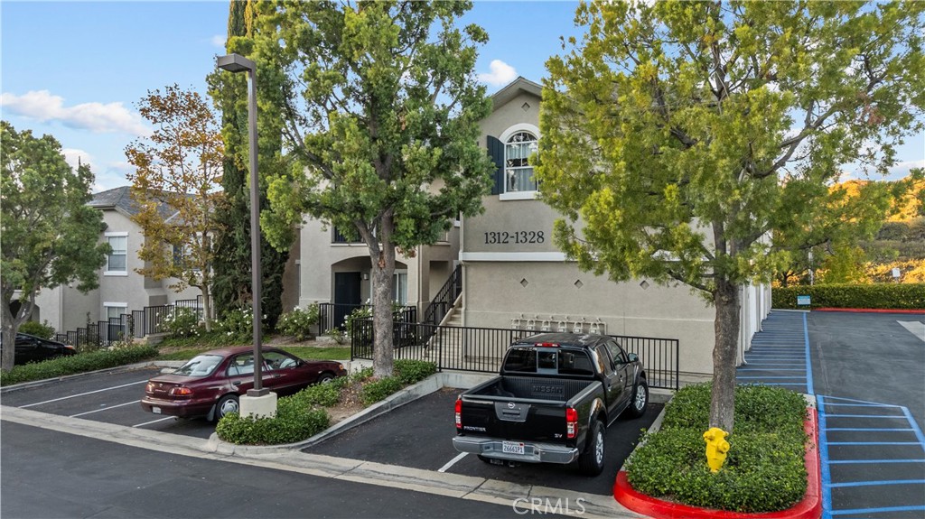 20000 Plum Canyon Road, Unit 1316 Saugus, CA 91350 - Photo 29 of 37 a view of a patio with table and chairs and potted plants