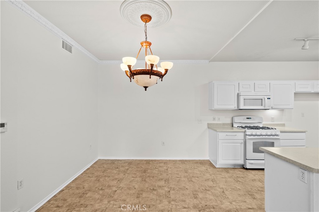 20000 Plum Canyon Road, Unit 1316 Saugus, CA 91350 - Photo 8 of 37 a kitchen with kitchen island stainless steel appliances a stove a sink and a refrigerator
