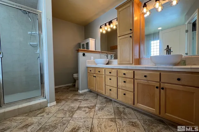 a spacious bathroom with a double vanity sink and a mirror
