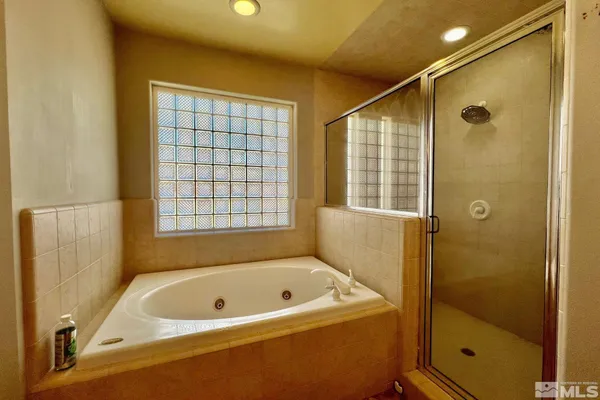 a bathroom with a tub and a shower