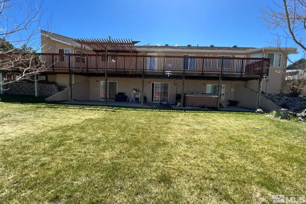a view of a backyard with wooden fence