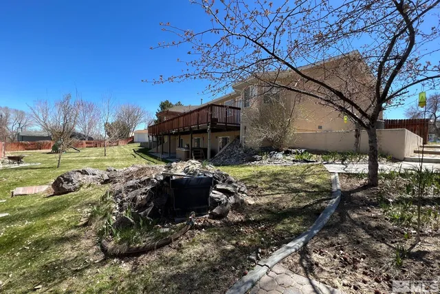 a view of a yard with a house in the background