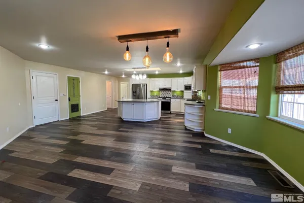 a room with lots of counter space and a wooden floor